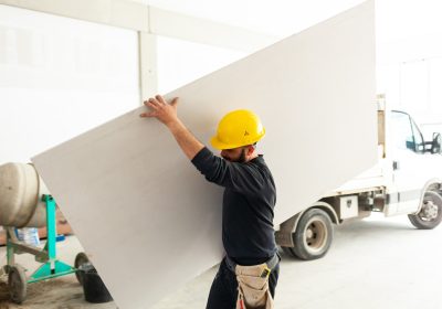 Worker builds a plasterboard wall. Worker builds a plasterboard wall.